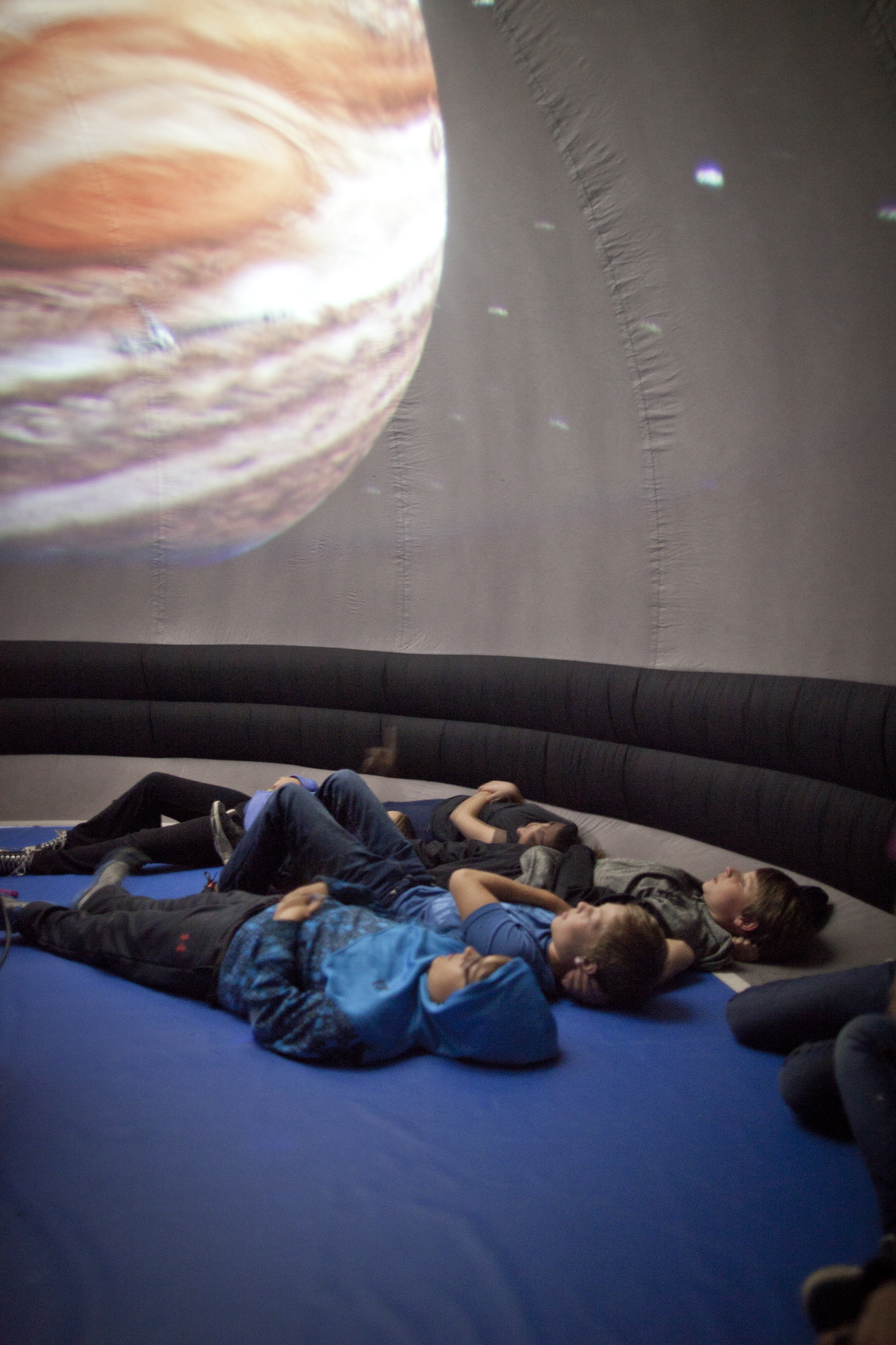 Students exploring other planets through Science North's planetarium presentation